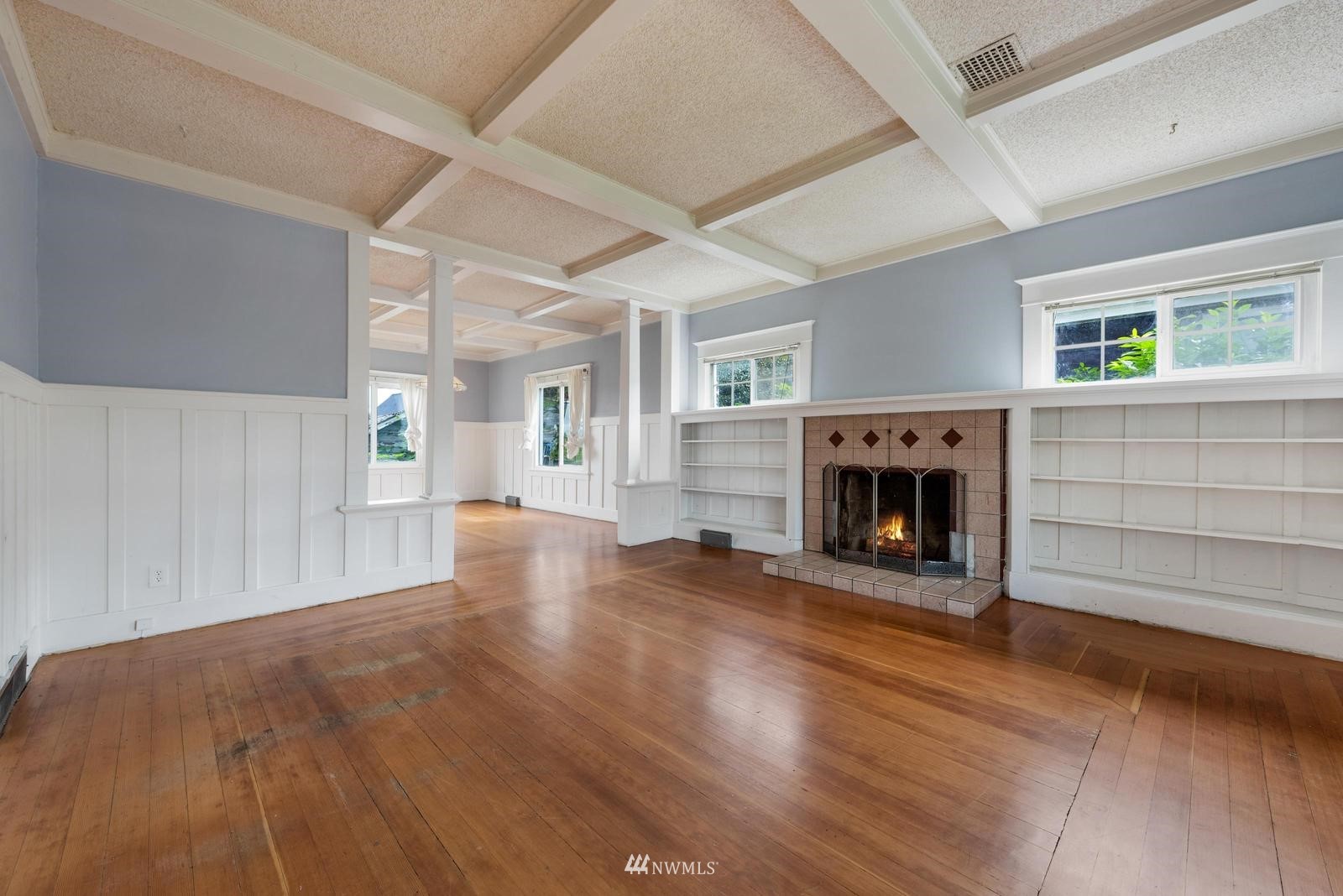 4852 South Orcas Street Seattle, WA 98118 - Photo 5 of 20 a view of a livingroom with a fireplace a fireplace and windows