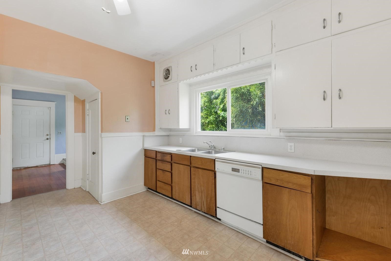 4852 South Orcas Street Seattle, WA 98118 - Photo 10 of 20 a kitchen with granite countertop white cabinets and a window