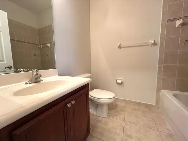 a bathroom with a sink a toilet a shower and a mirror