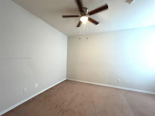 an empty room with a empty space and a ceiling fan