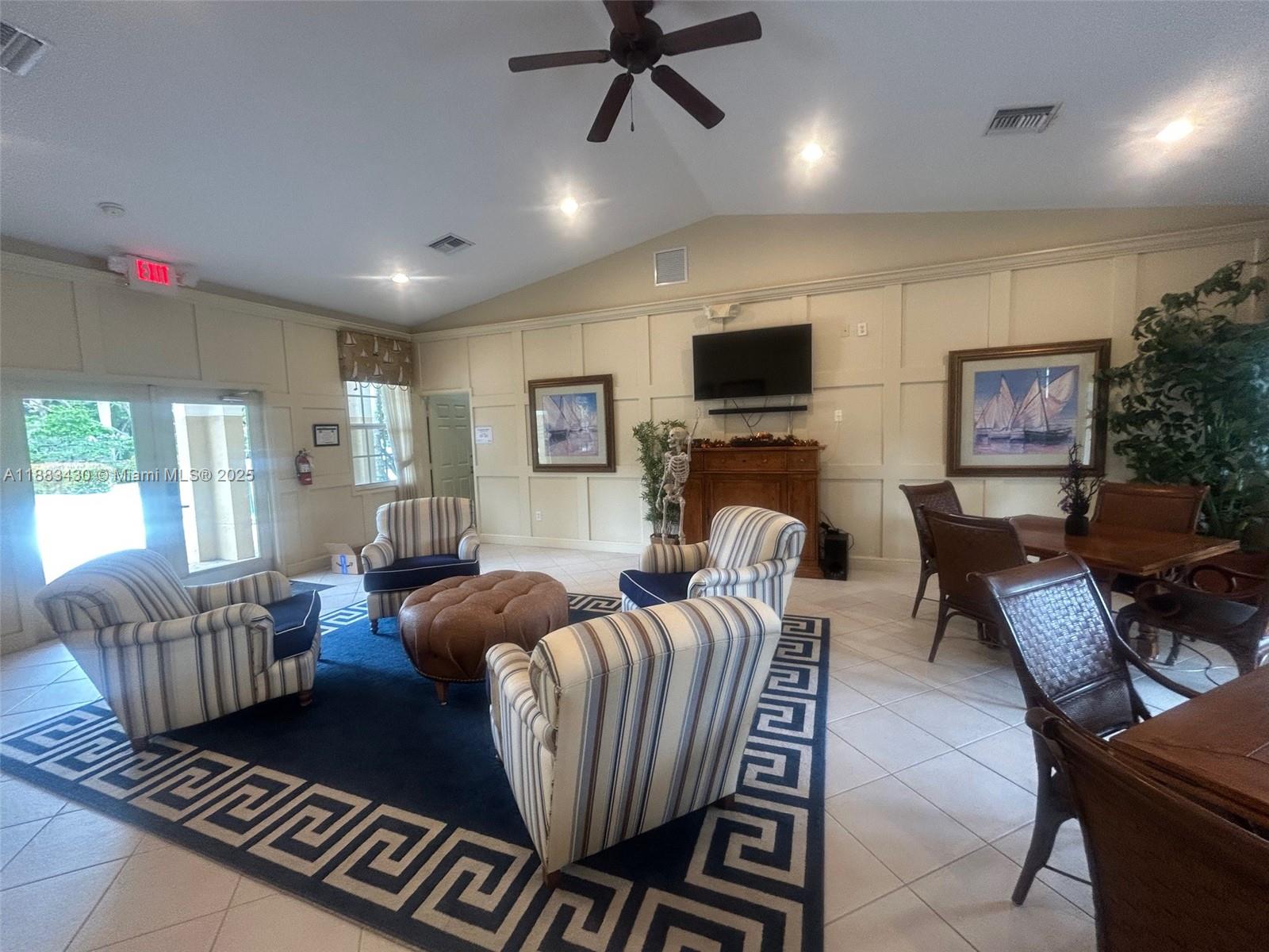 1560 Southeast Wilshire Place, Unit 103 Stuart, FL 34994 - Photo 32 of 33 a living room with furniture or couch and a flat screen tv