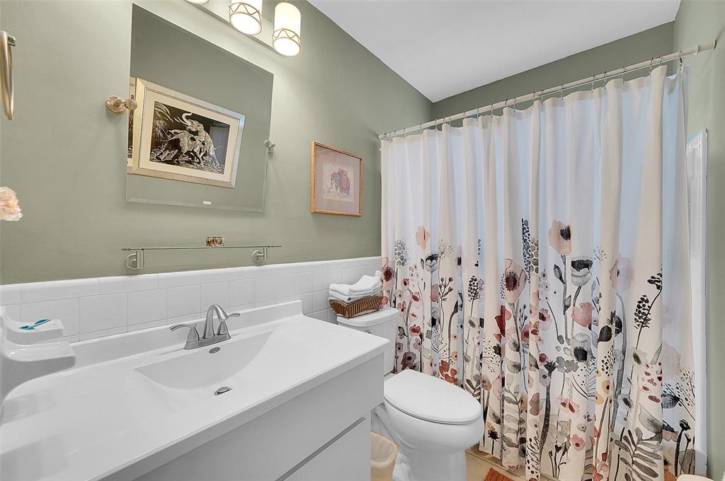 4600 Northwest 45th Street Tamarac, FL 33319 - Photo 11 of 15 a bathroom with a sink mirror and toilet