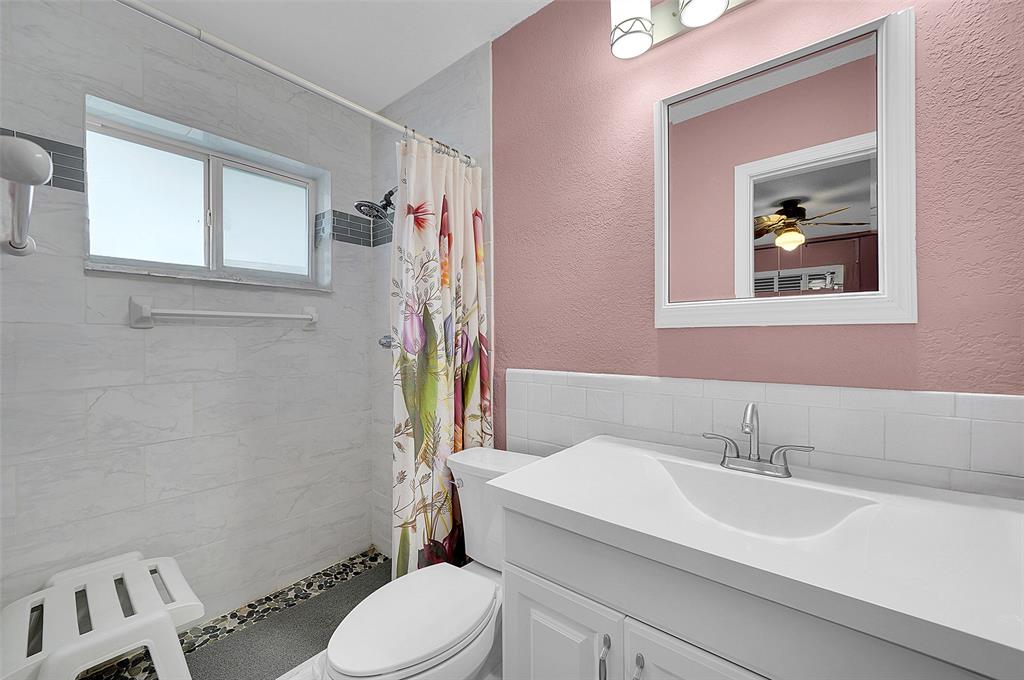 4600 Northwest 45th Street Tamarac, FL 33319 - Photo 13 of 15 a bathroom with a sink mirror and toilet