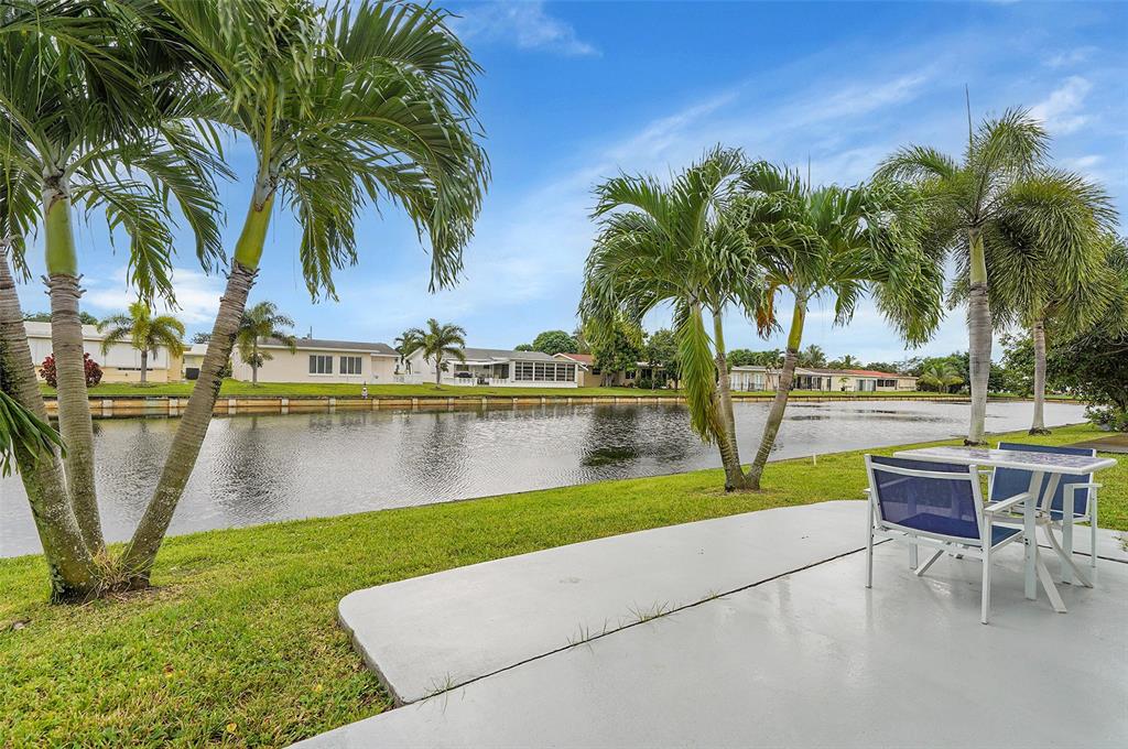 4600 Northwest 45th Street Tamarac, FL 33319 - Photo 15 of 15 a view of a lake with a table and chairs