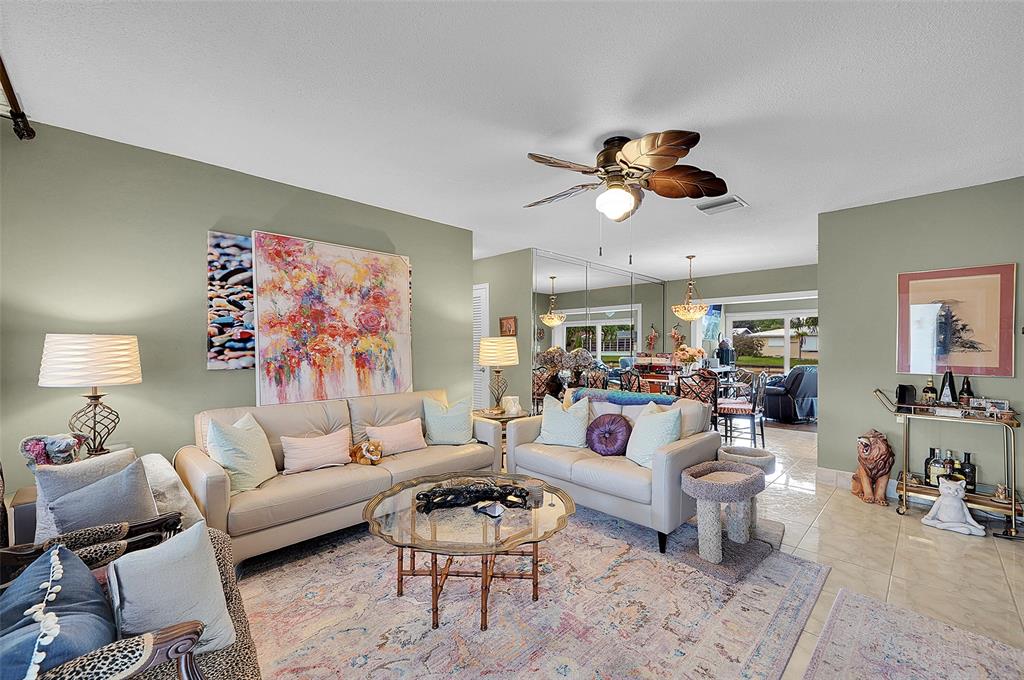 4600 Northwest 45th Street Tamarac, FL 33319 - Photo 4 of 15 a living room with furniture a rug and a chandelier