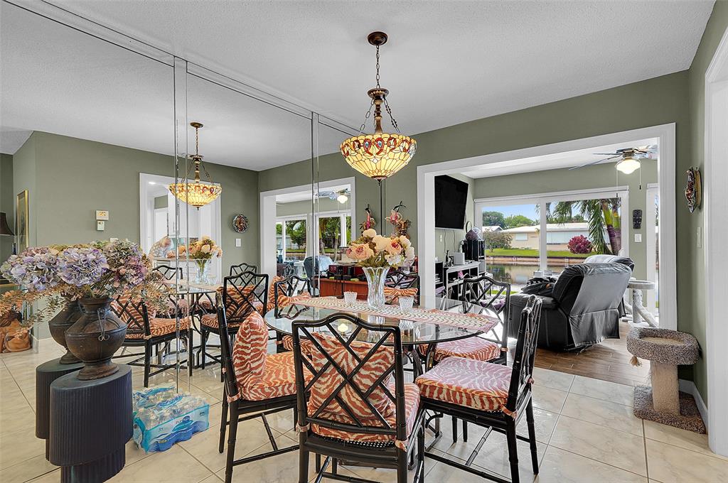 4600 Northwest 45th Street Tamarac, FL 33319 - Photo 6 of 15 a view of a dining room with furniture and chandelier