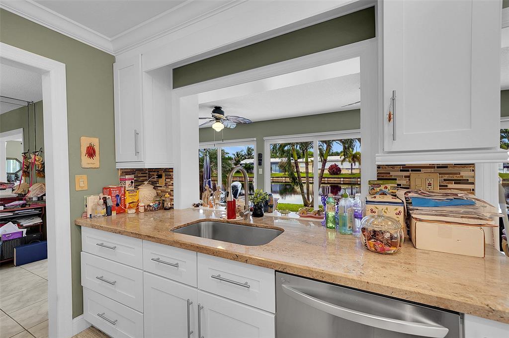 4600 Northwest 45th Street Tamarac, FL 33319 - Photo 8 of 15 a kitchen with sink a stove and cabinets