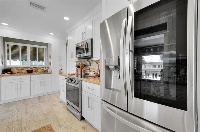 a kitchen with stainless steel appliances a refrigerator sink and stove