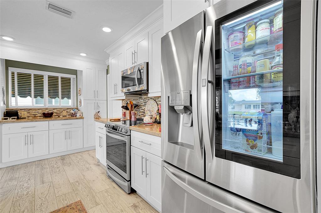 4600 Northwest 45th Street Tamarac, FL 33319 - Photo 10 of 15 a kitchen with stainless steel appliances a refrigerator sink and microwave