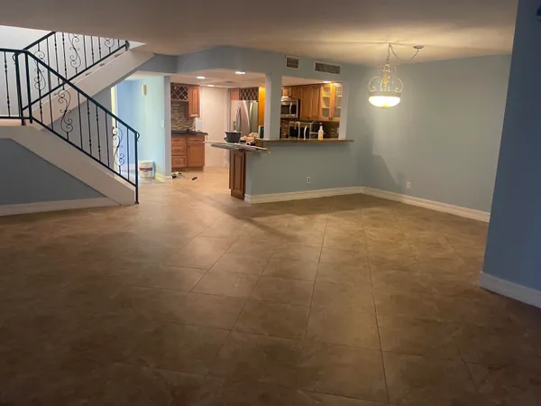 a view of a livingroom with wooden floor and staircase