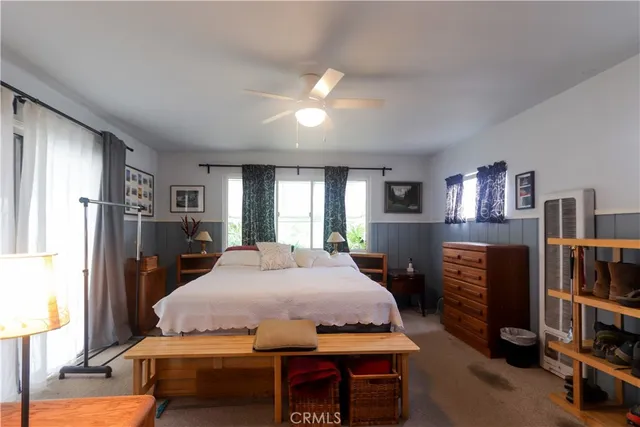 a bedroom with furniture and a flat screen tv