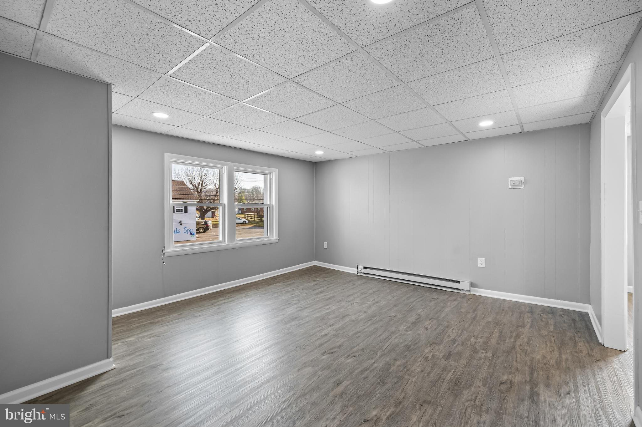 1480 Seven Valleys Road, Unit 2 York, PA 17408 - Photo 7 of 19 an empty room with wooden floor and windows