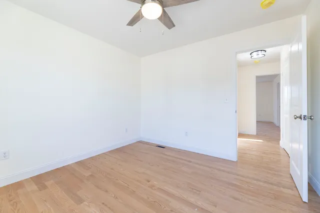 a view of a room with wooden floor
