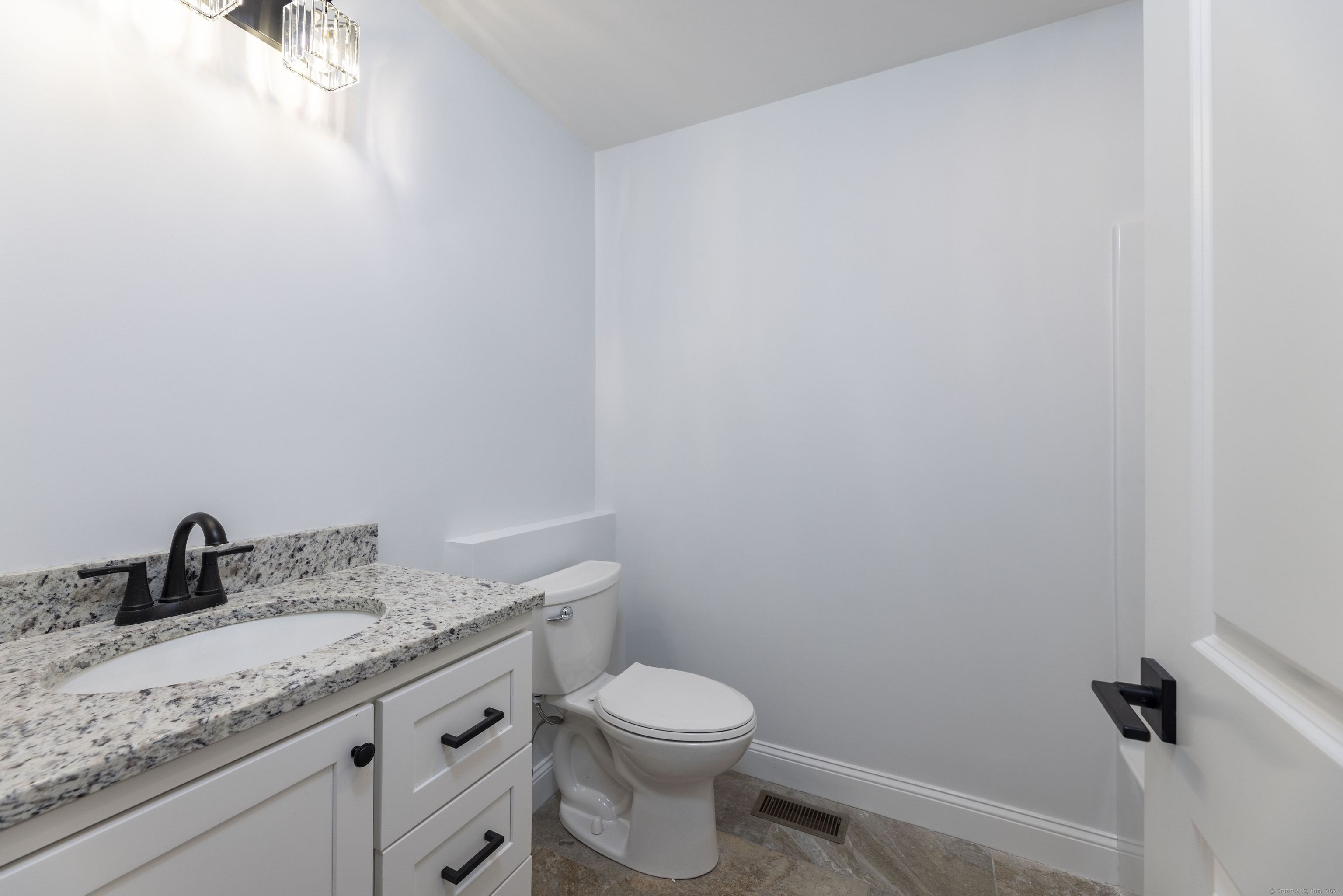 8 John's Circle Sterling, CT 06377 - Photo 13 of 29 a bathroom with a granite countertop sink vanity mirror and toilet