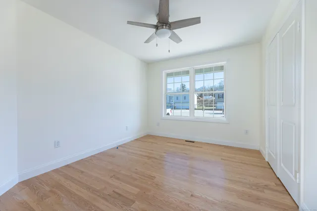 wooden floor in an empty room with a window