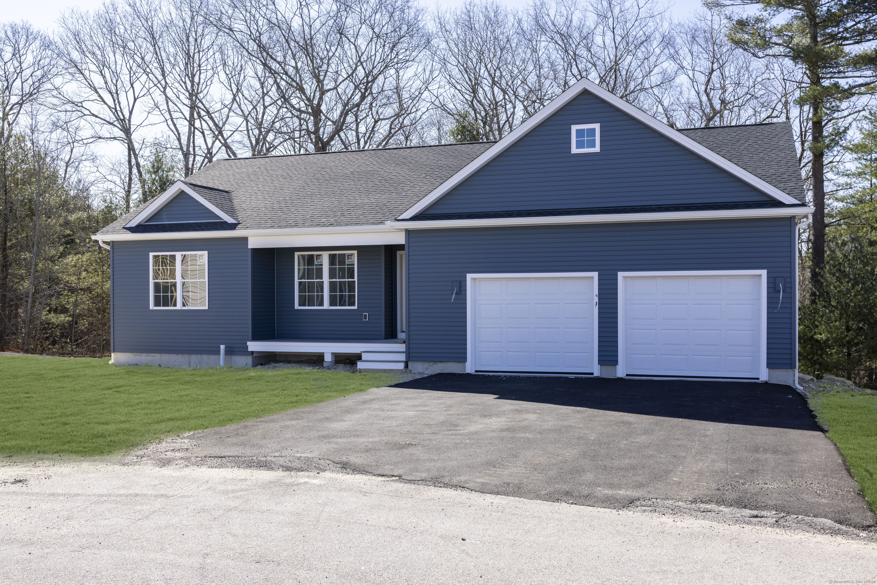 8 John's Circle Sterling, CT 06377 - Photo 21 of 29 a front view of a house with a yard and garage