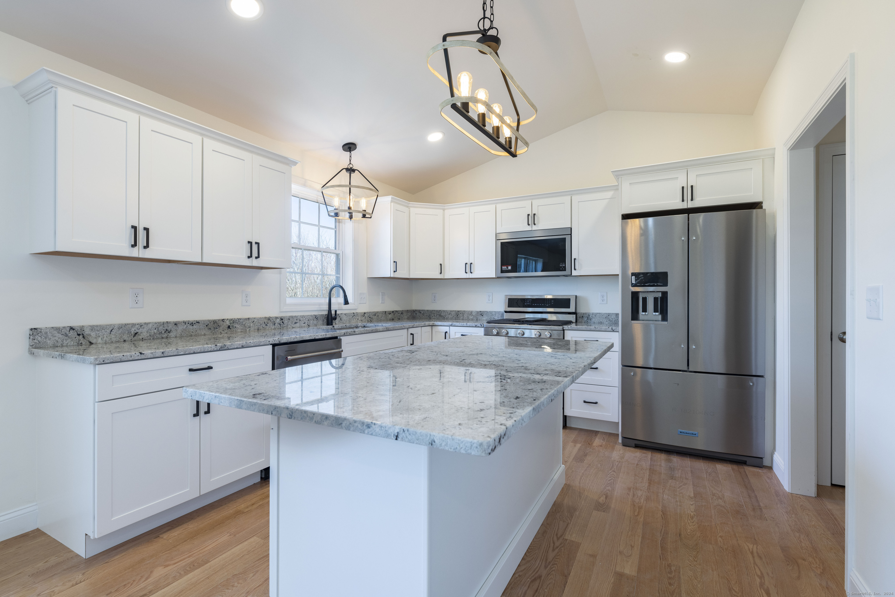 8 John's Circle Sterling, CT 06377 - Photo 24 of 29 a kitchen with stainless steel appliances granite countertop a refrigerator a stove a sink and white cabinets