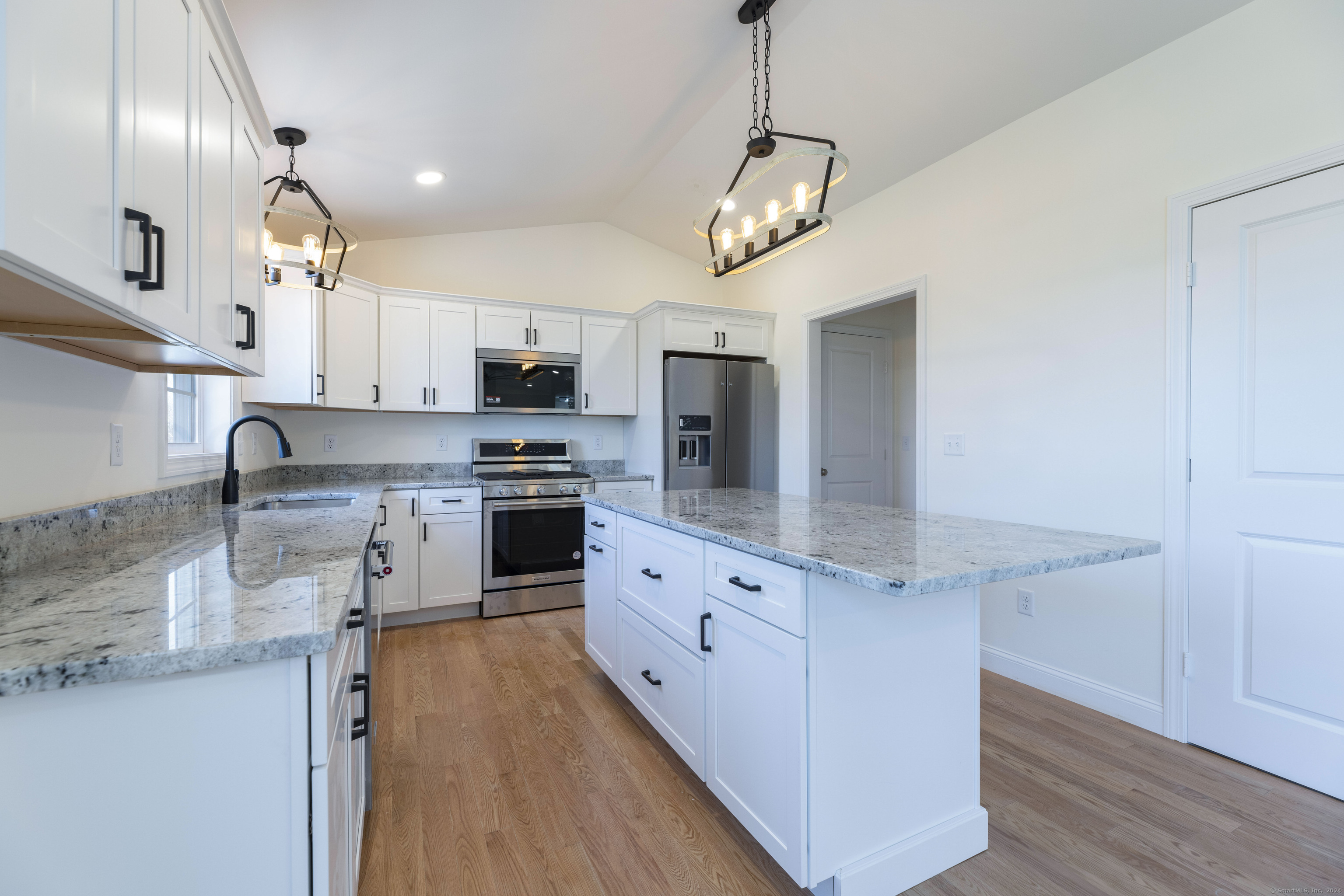8 John's Circle Sterling, CT 06377 - Photo 3 of 29 a kitchen with stainless steel appliances granite countertop a sink a stove and a refrigerator