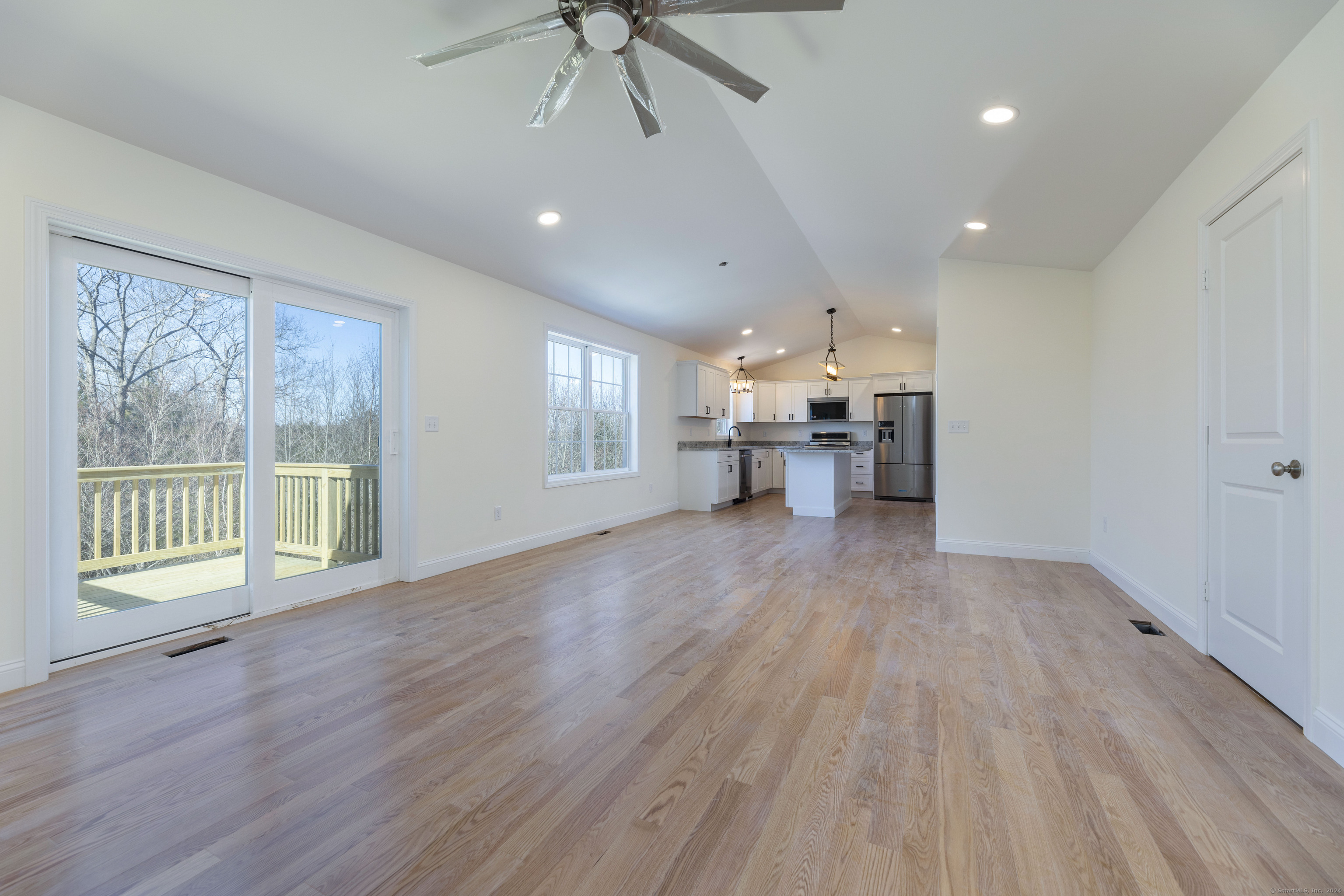 8 John's Circle Sterling, CT 06377 - Photo 6 of 29 a view of an empty room with a window and wooden floor