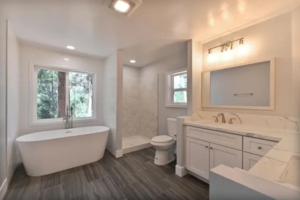 a kitchen with stainless steel appliances granite countertop a refrigerator sink and microwave