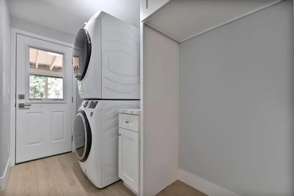 an empty room with closet and fan