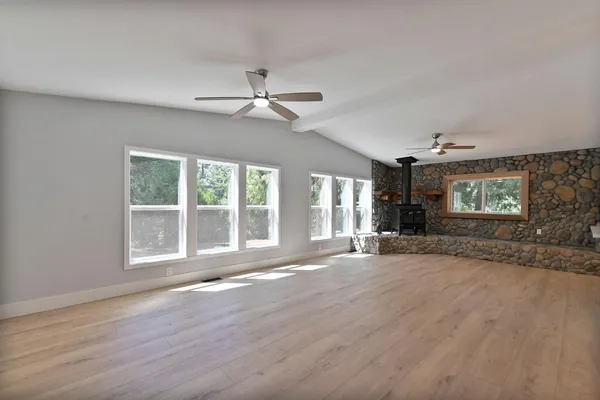 a view of a livingroom with a hardwood floor and a ceiling fan