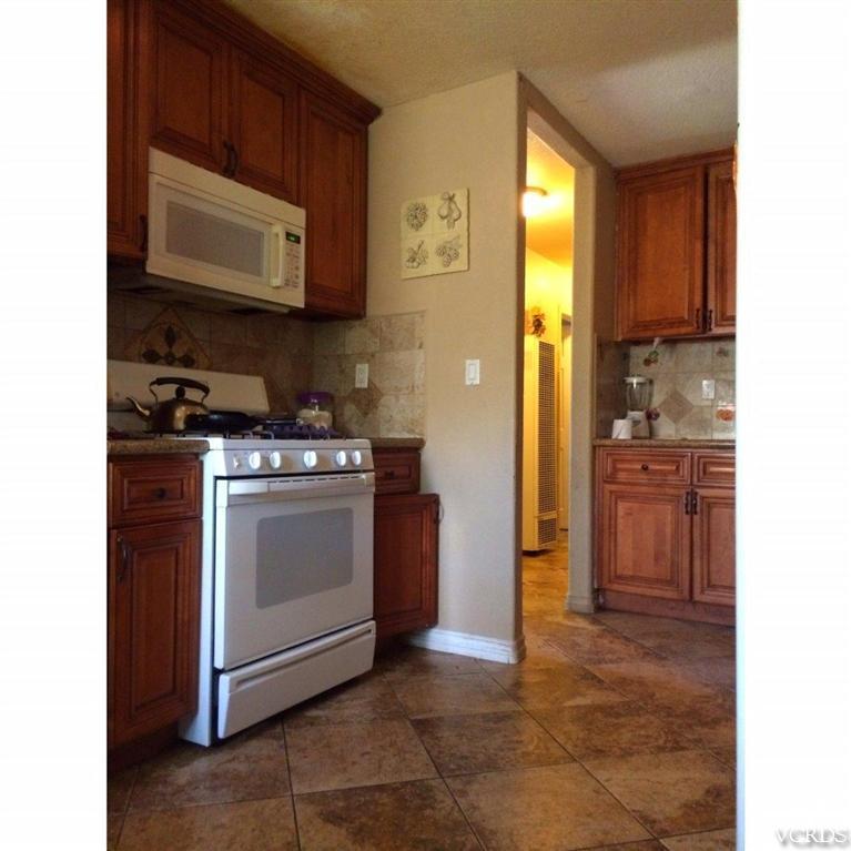 3354 Sycamore Street Oxnard, CA 93033 - Photo 4 of 7 a kitchen with stainless steel appliances granite countertop a stove a microwave and a refrigerator