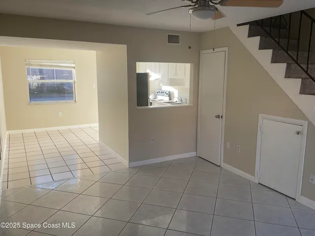 a view of a balcony with two chairs and a table