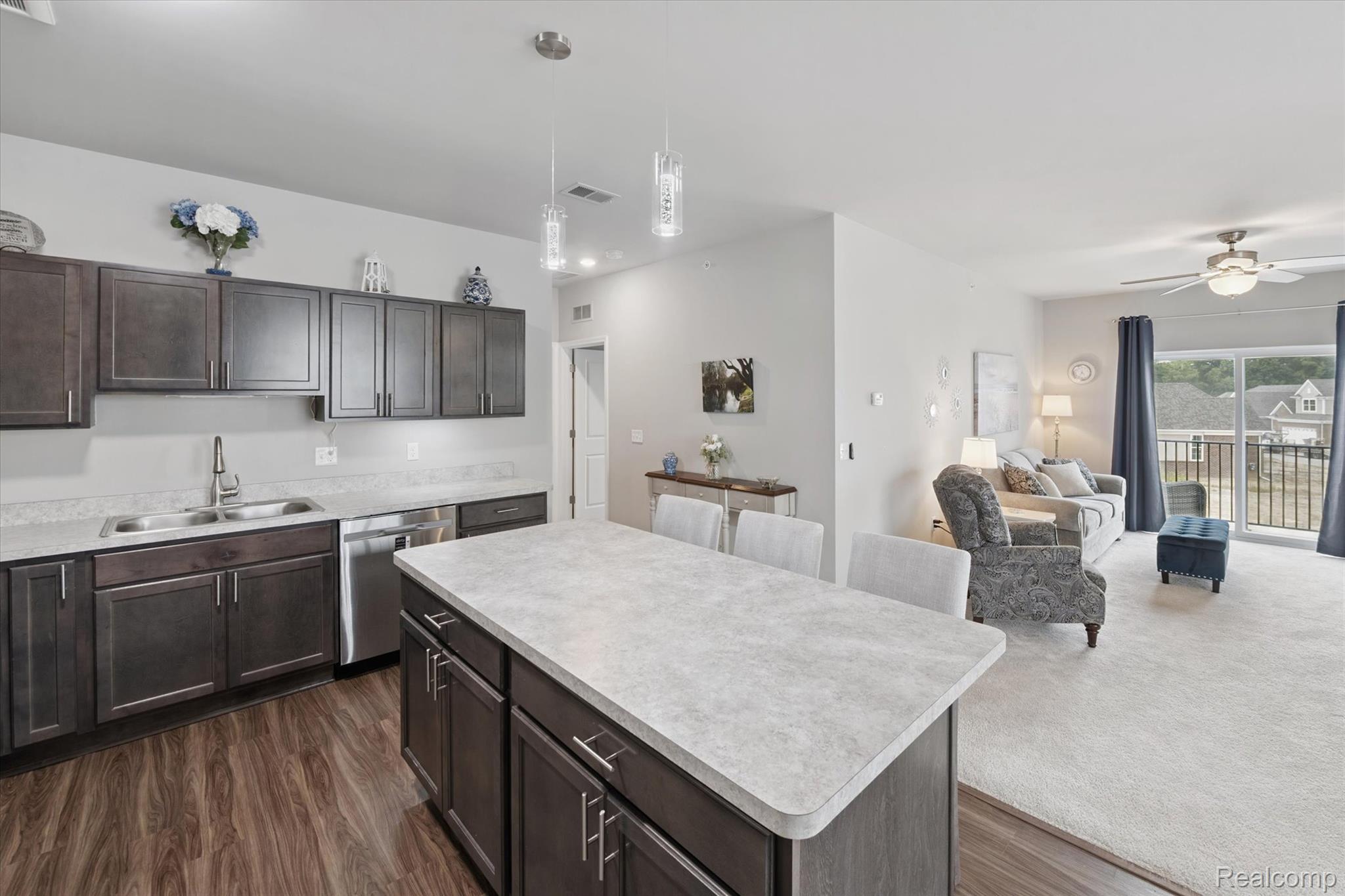 9868 Ridge Run Street Howell, MI 48855 - Photo 6 of 19 Vinyl plank flooring and modern pendant lighting