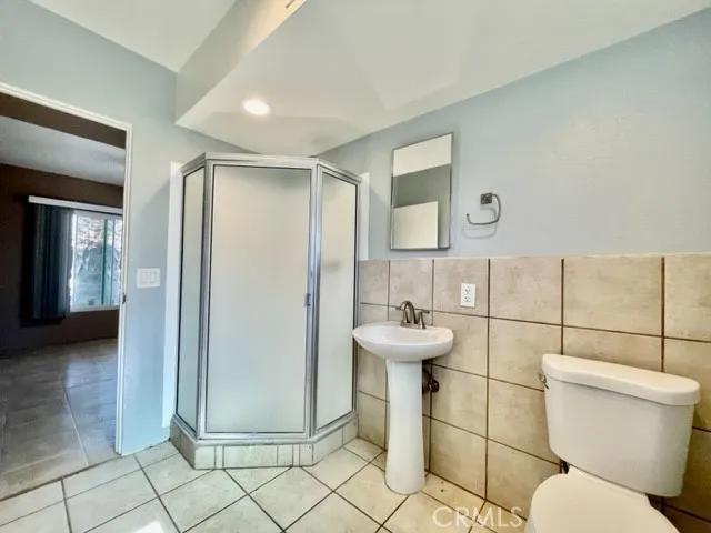 a bathroom with a toilet sink and shower