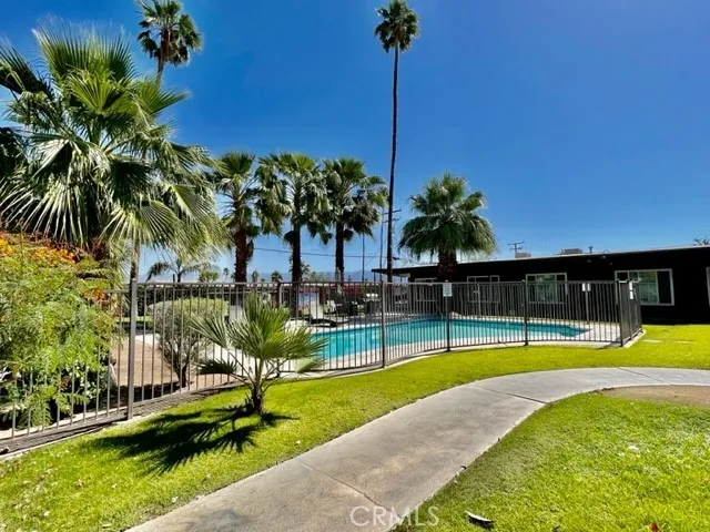 a view of a swimming pool with a table and chairs