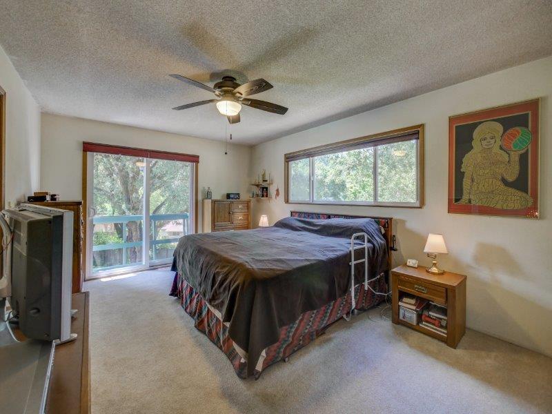224 Circle Drive Ben Lomond, CA 95005 - Photo 16 of 34 a spacious bedroom with a bed and a flat tv screen on dresser