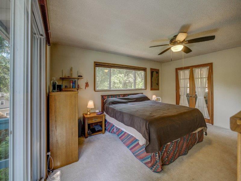 224 Circle Drive Ben Lomond, CA 95005 - Photo 34 of 34 a bedroom with a bed and a chandelier