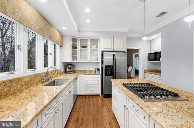 a living room with furniture kitchen view and a window