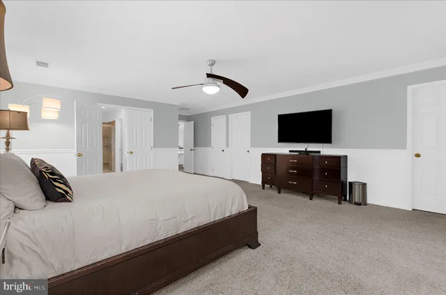 a balcony with wooden floor table and chairs