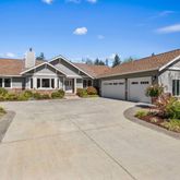 a front view of a house with a yard and outdoor seating