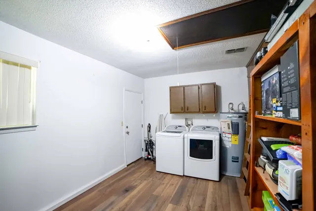 a view of a kitchen with fridge and wooden floor