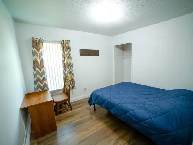 a bedroom with a bed and chair