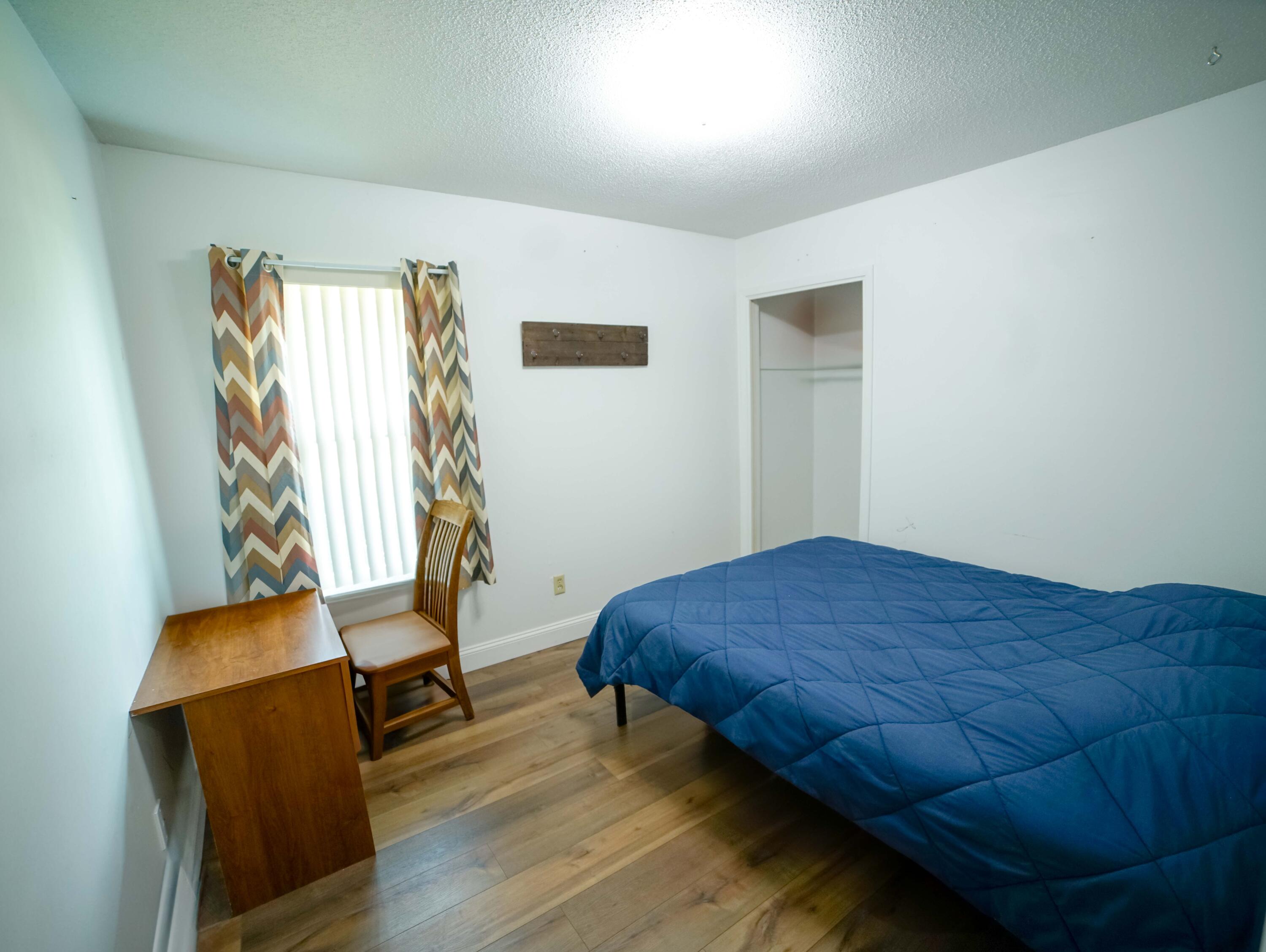 74 8th Street Shalimar, FL 32579 - Photo 15 of 26 a bedroom with a bed and chair