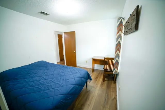 a bedroom with a bed and a chair