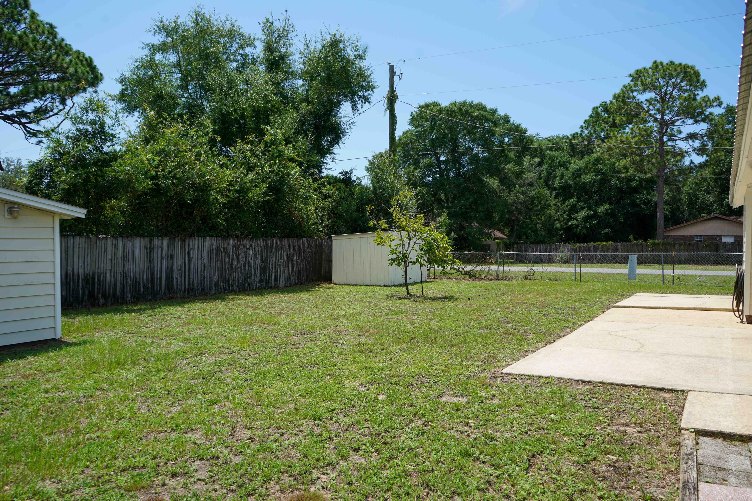 74 8th Street Shalimar, FL 32579 - Photo 23 of 26 a view of a backyard with a garden and entertaining space