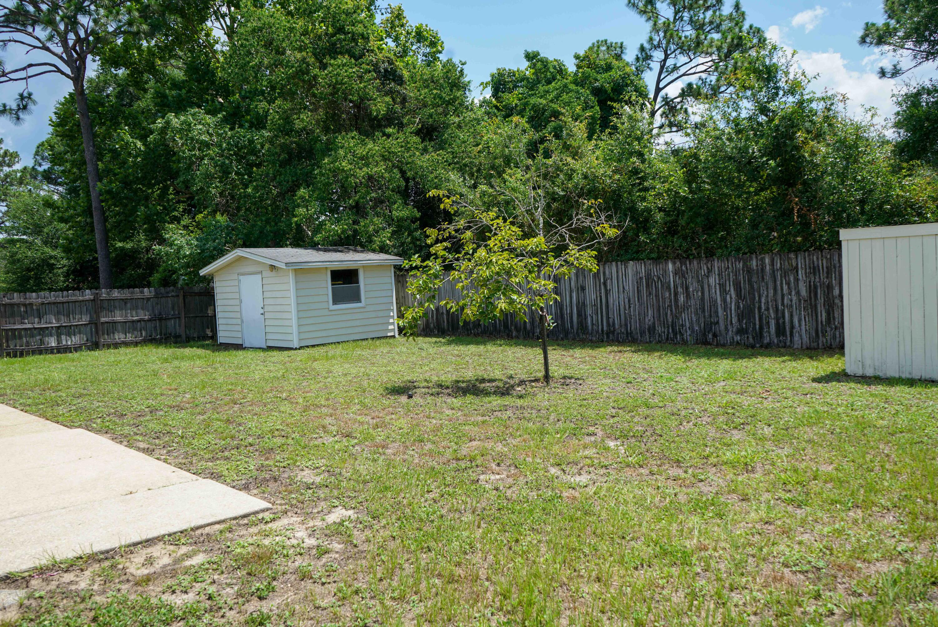 74 8th Street Shalimar, FL 32579 - Photo 24 of 26 a house with swimming pool in front of it