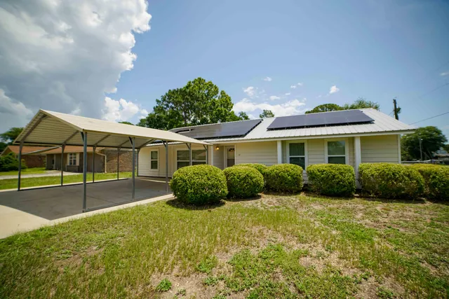 a front view of house with yard and outdoor seating