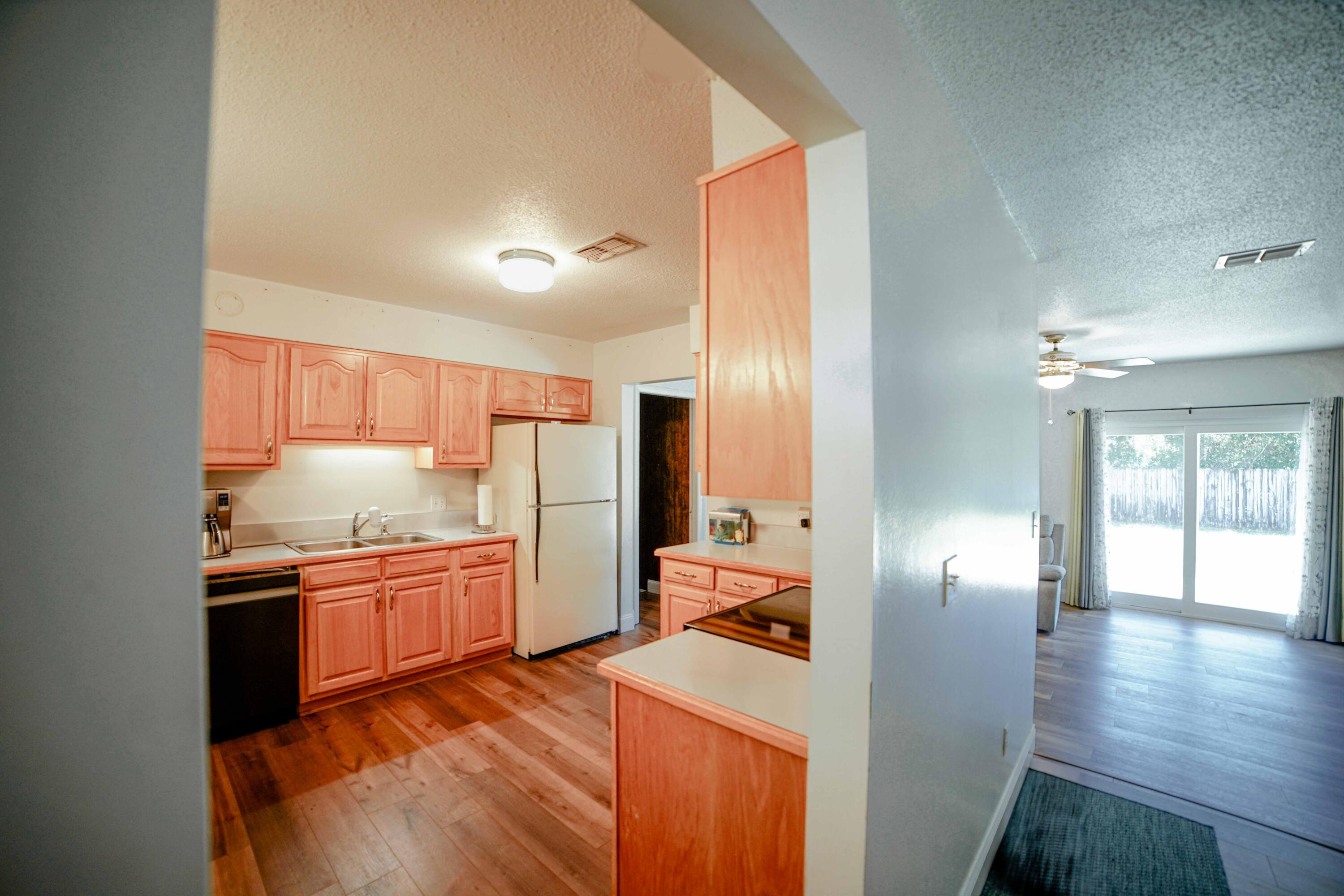 74 8th Street Shalimar, FL 32579 - Photo 7 of 26 a kitchen with stainless steel appliances granite countertop a sink stove and refrigerator