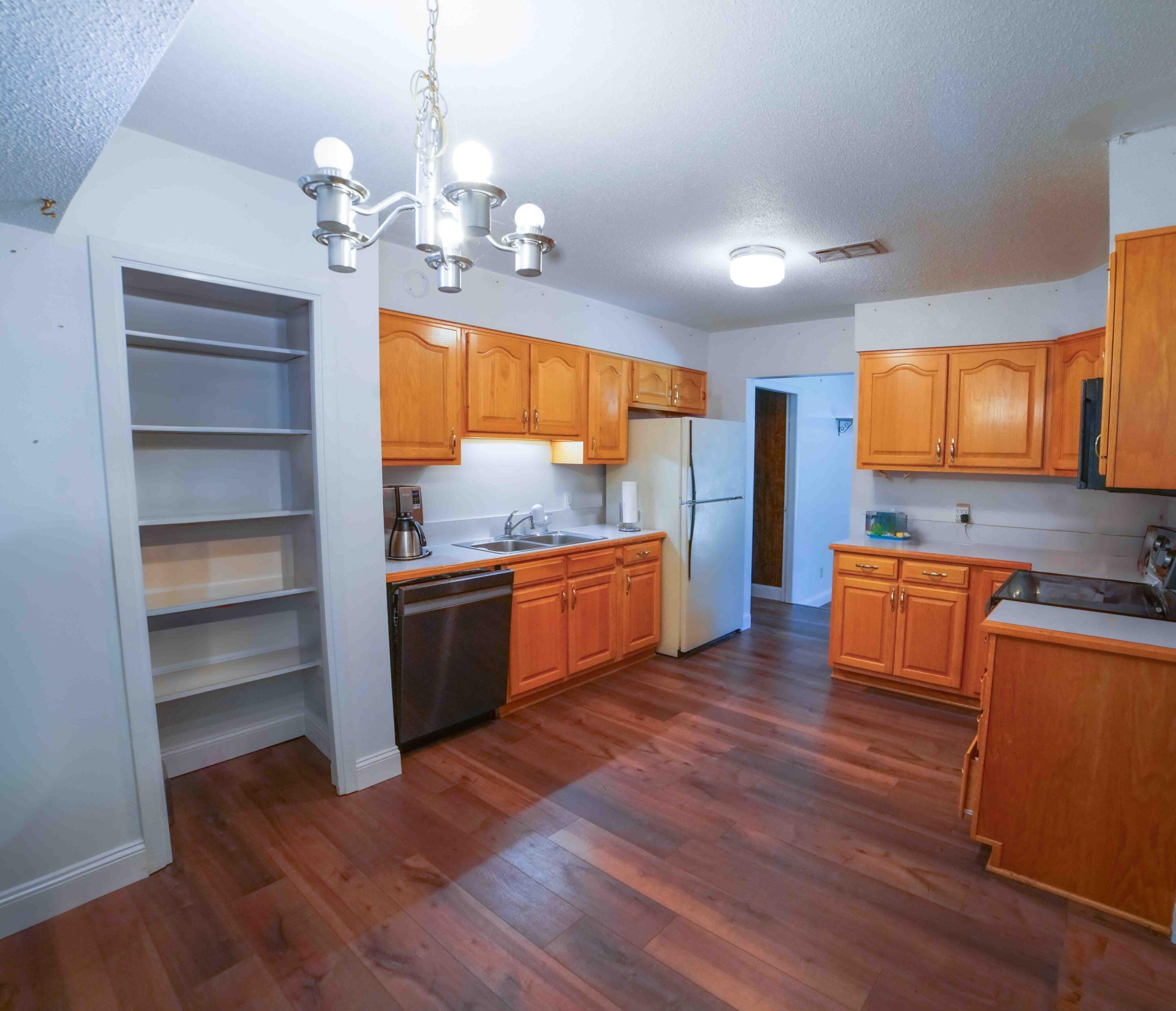 74 8th Street Shalimar, FL 32579 - Photo 8 of 26 a kitchen with wooden floors and appliances