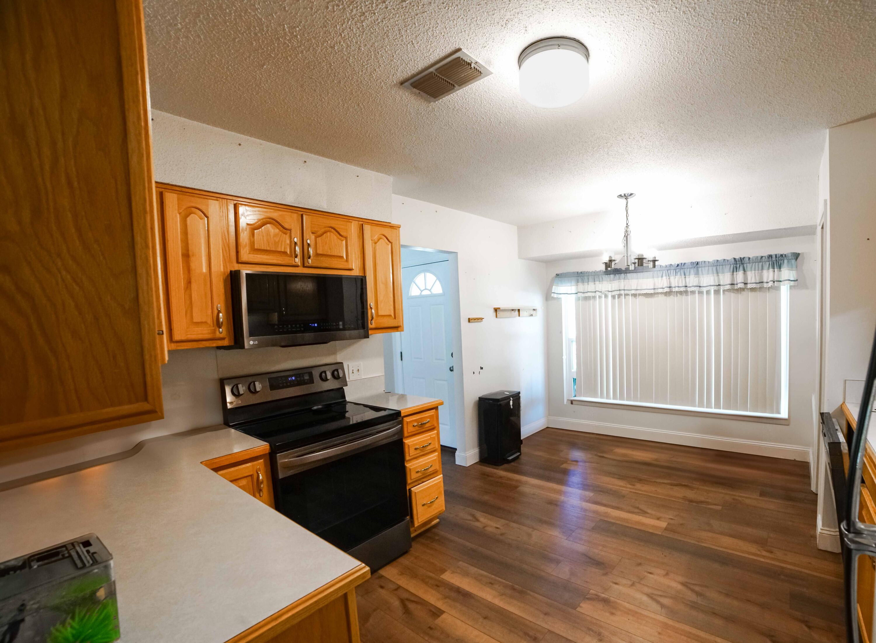 74 8th Street Shalimar, FL 32579 - Photo 9 of 26 a living room with a flat screen tv and wooden floor