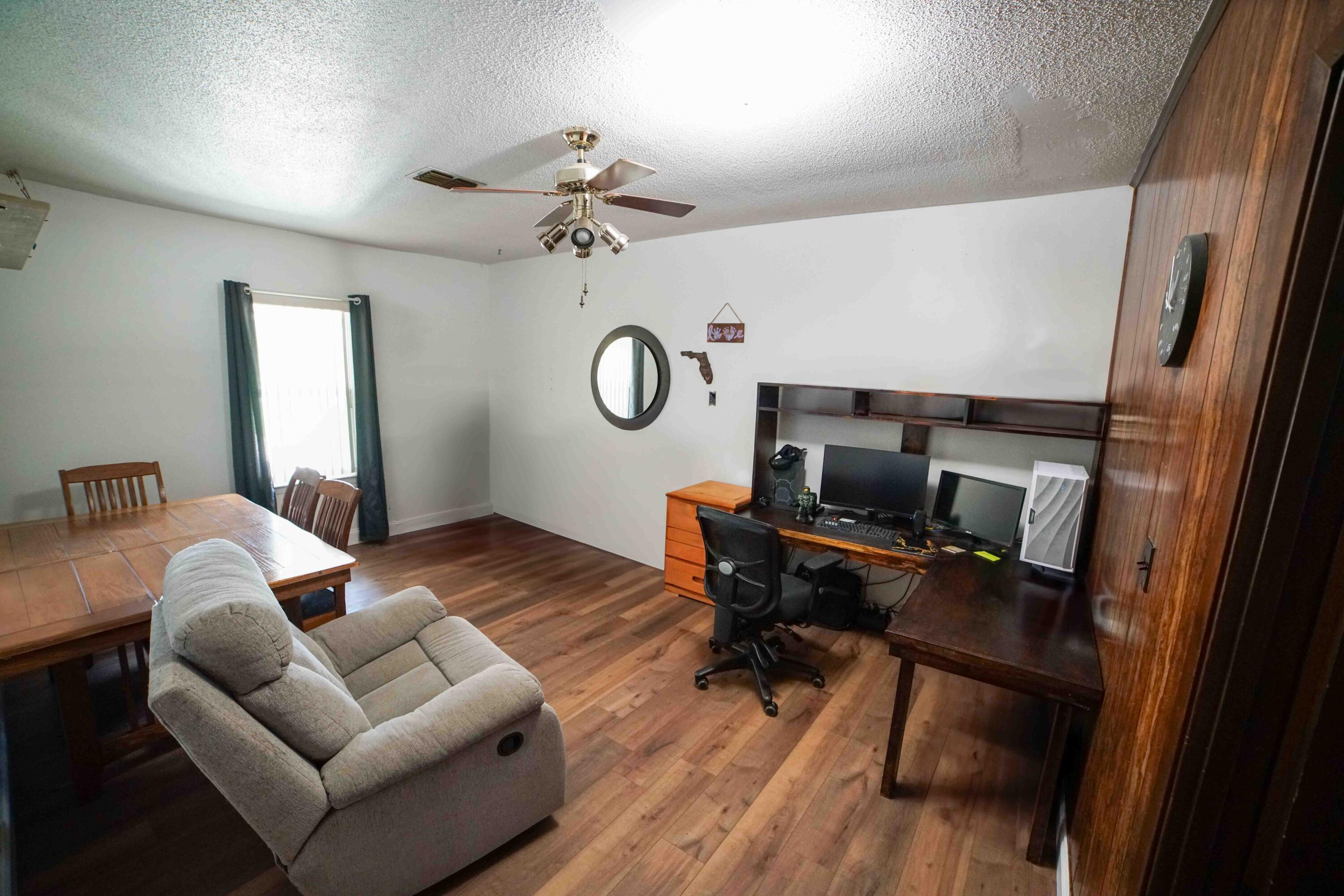 74 8th Street Shalimar, FL 32579 - Photo 10 of 26 a bedroom with furniture and a wooden floor