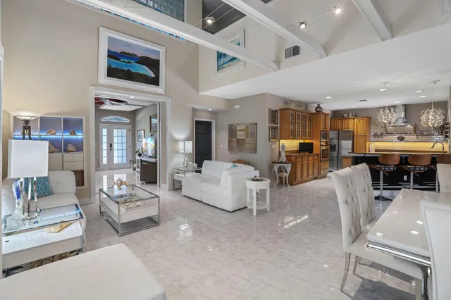 a living room with furniture and a floor to ceiling window