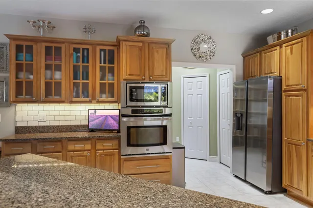 a view of a porch with furniture and floor to ceiling window
