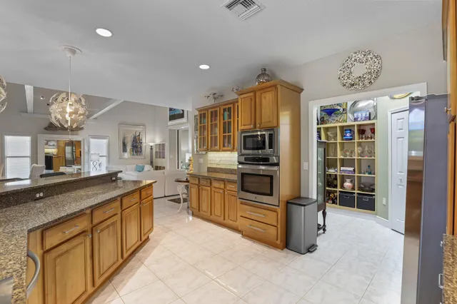 a bathroom with a granite countertop toilet a sink and mirror